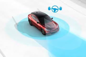 Red car demonstrating autonomous driving technology, with blue sensor fields and a steering wheel icon.