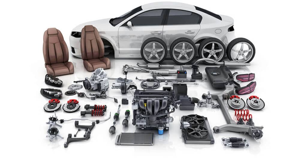 Car with assorted parts, including seats, wheels, engine, and suspension components arranged in front.