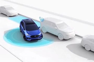 Blue car using autonomous driving technology, highlighted by radar waves, among white vehicles.